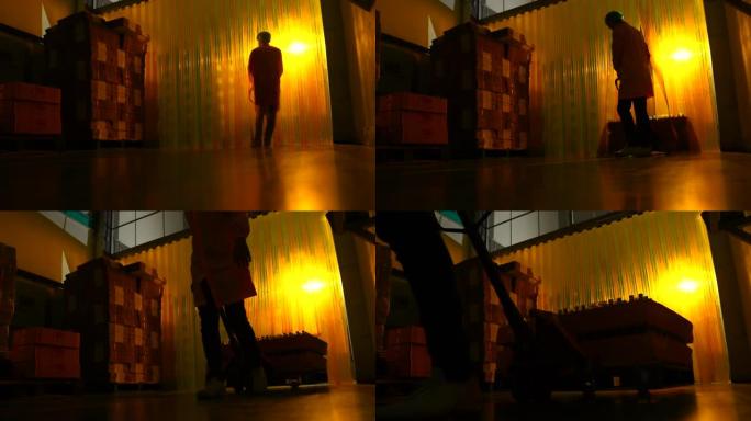 男性工人在纸箱工厂中数产品，使用轮廓技术拍摄以显示工人的轮廓。
