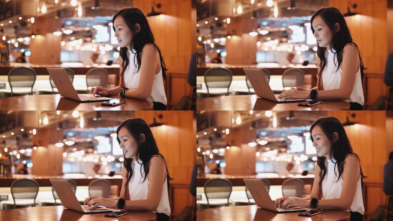 亚洲女商人在咖啡店使用笔记本电脑