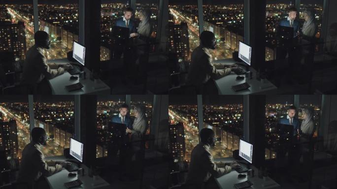 多元化的工作狂同事在办公室晚上赶上最后期限