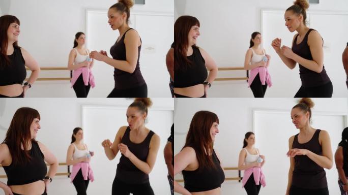 女人在健身舞蹈课休息时互相交谈