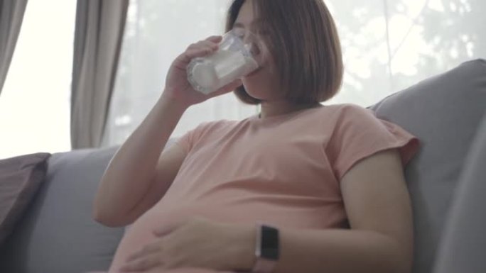 健康孕妇亚洲妇女在子宫内喝牛奶保健婴儿