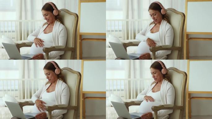 孕妇坐在扶手椅上，使用笔记本电脑进行视频通话