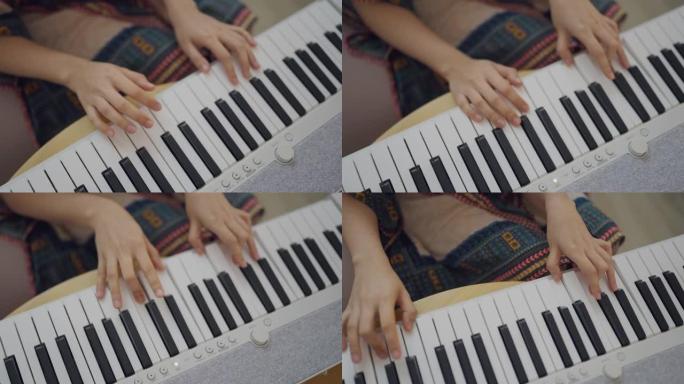 家庭独自键盘钢琴爱好年轻女子练习钢琴。