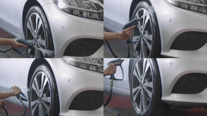 汽车清洁剂使用喷水喷雾清洁汽车底盘。