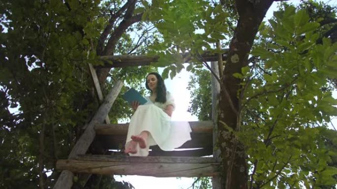 慢动作年轻女子在树屋上读书
