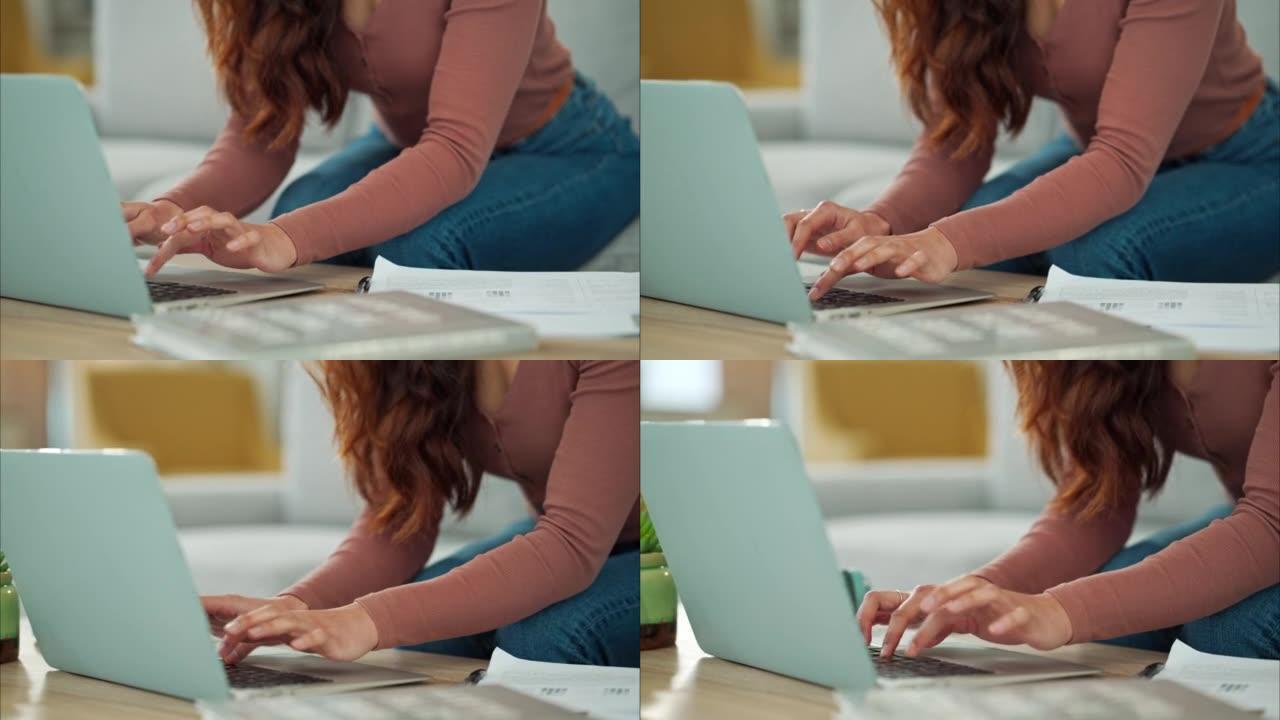 女人，手和笔记本电脑坐在家里沙发上的客厅桌子上打字商务电子邮件。在计算机上远程工作的创造性女员工的手