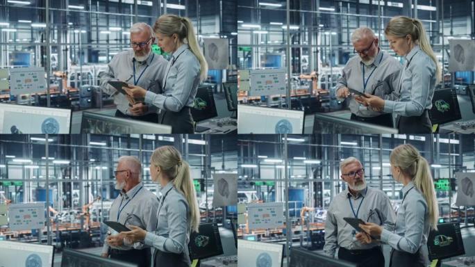 汽车厂办公室: 科学家与高级工程师会谈，使用平板电脑设计先进动力发动机的生产输送机。自动机械臂装配线