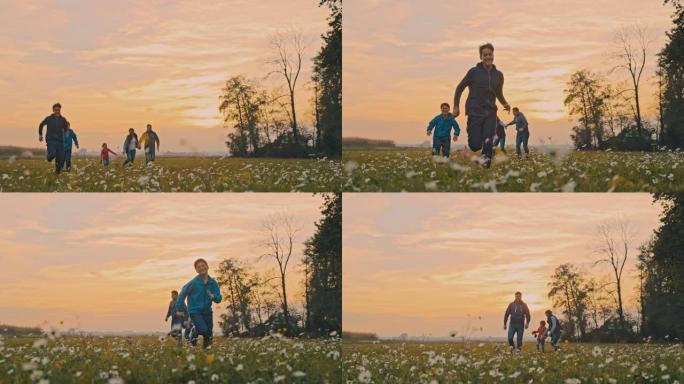 SLO MO Young家庭在日落时在草地上奔跑的乐趣