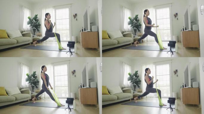女人在家用手机练习瑜伽。
