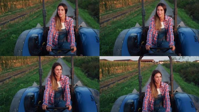 一名年轻女子在绿色的玉米田旁在路上驾驶拖拉机的中等镜头。女农民在清晨开始她的工作任务。一个反对陈规定