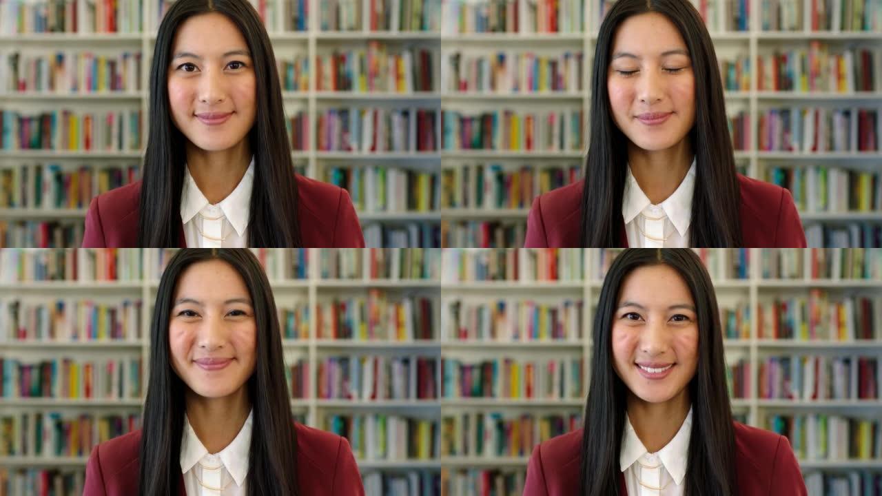 学校图书馆里微笑的亚洲学生的肖像。一个可爱的快乐女孩带着酒窝在书店里寻找小说阅读的头像。年轻友好的图
