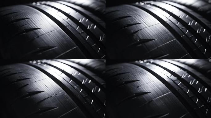 现代高性能运动夏季轮胎滚动，孤立在黑色背景上