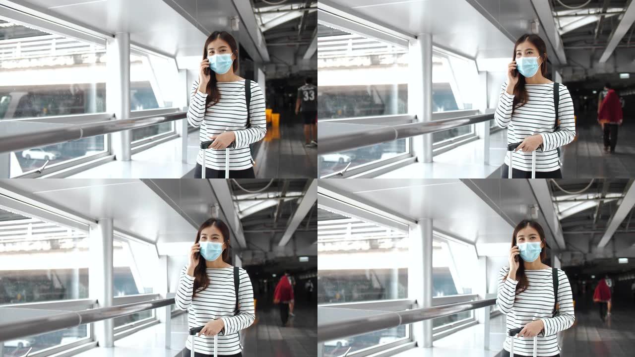 亚洲妇女戴着口罩进入机场航站楼