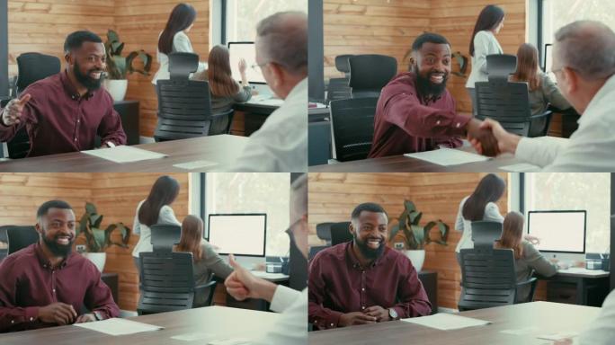 在办公室开会后，一个英俊的年轻商人坐着和同事握手的4k录像