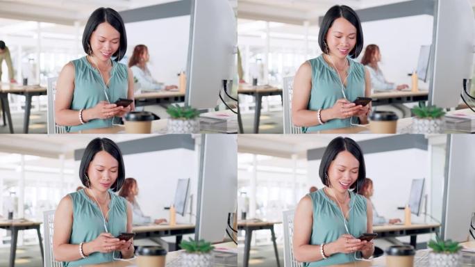 富有创造力的亚洲女性，社交媒体的电话和短信，在办公室用电脑聊天或发帖。快乐的女人，微笑着在工作中通过