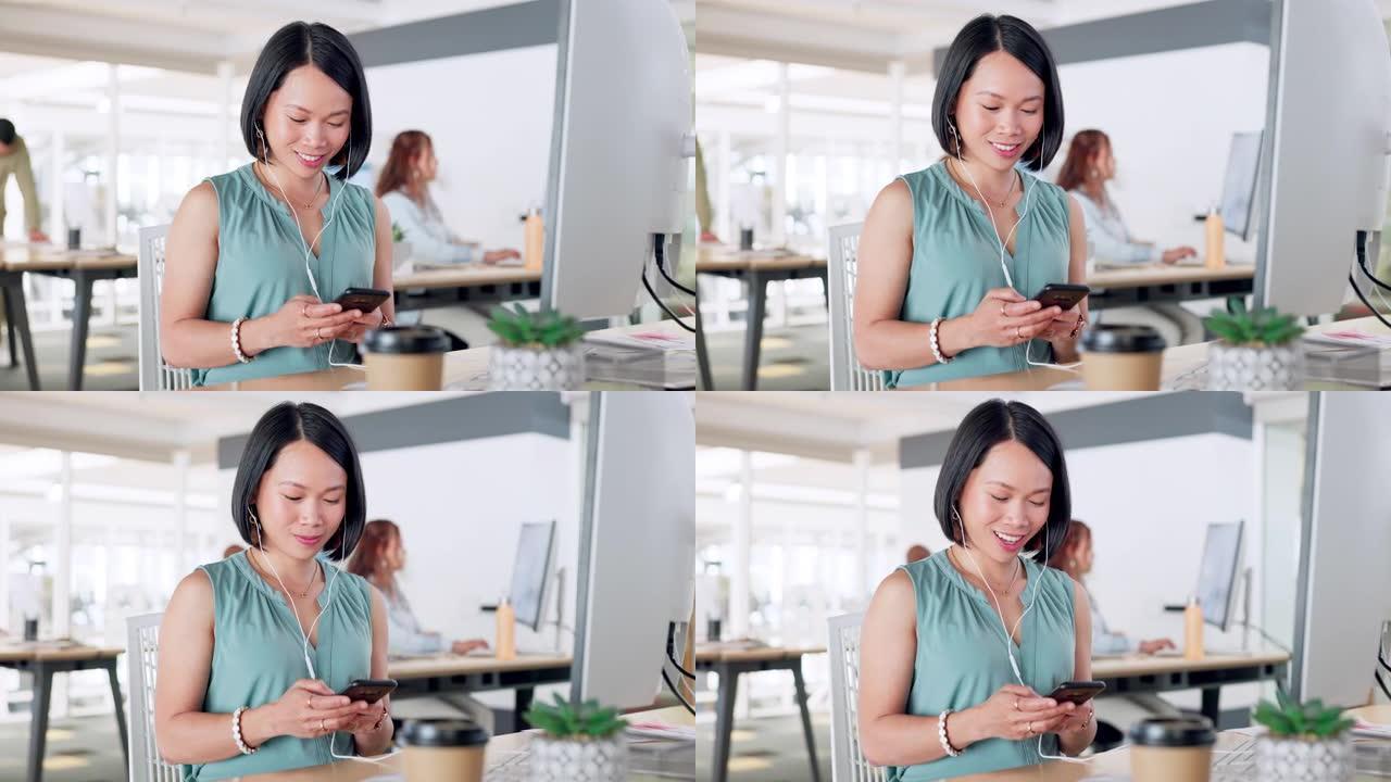 富有创造力的亚洲女性，社交媒体的电话和短信，在办公室用电脑聊天或发帖。快乐的女人，微笑着在工作中通过