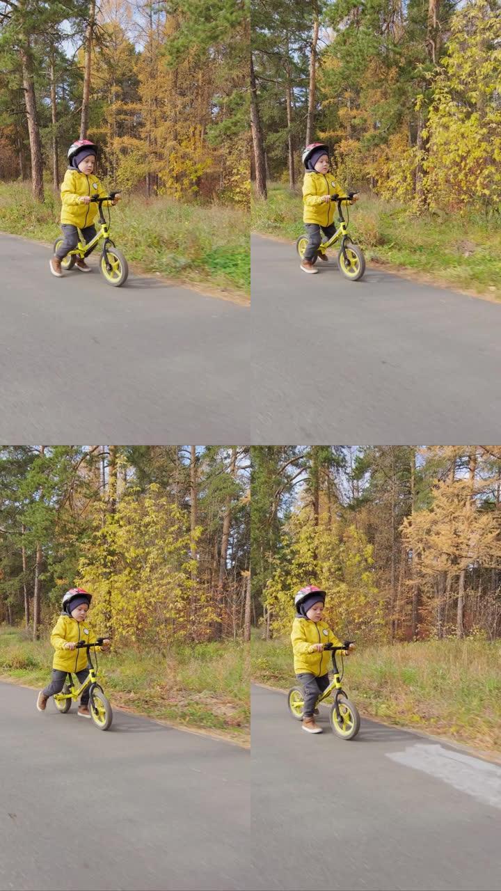 男孩骑平衡自行车的垂直慢速
