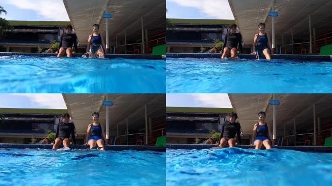 池畔的亚洲中国成熟女性与教练一起用潜水鳍翻水