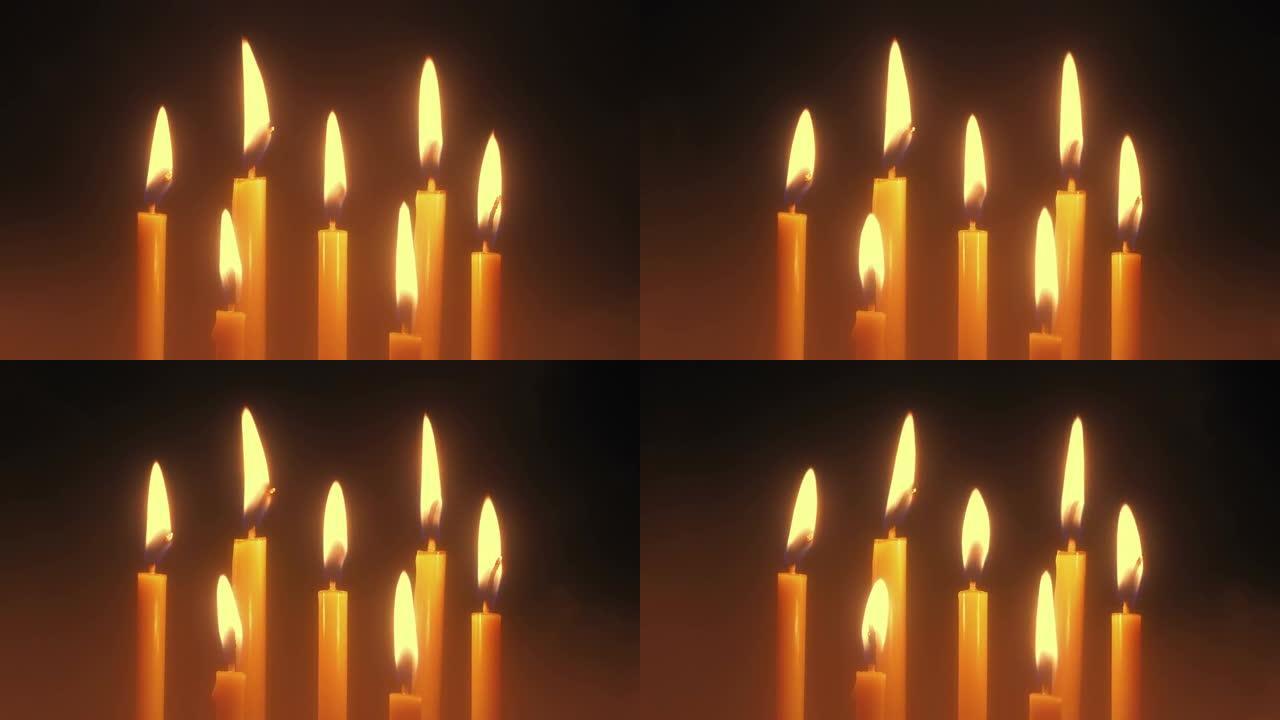 一组蜡烛在烟熏的气氛中燃烧和吹灭