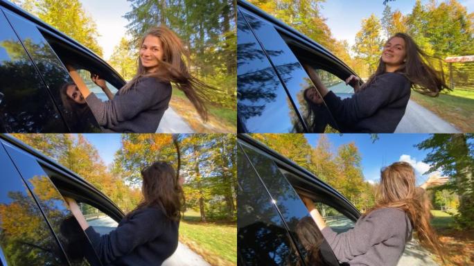 女人玩得开心，开车穿过秋天的森林时从车窗外倾斜