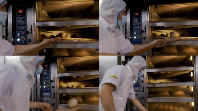 拉丁美洲面包师从食品加工厂的工业烤箱中取出新鲜的烤面包
