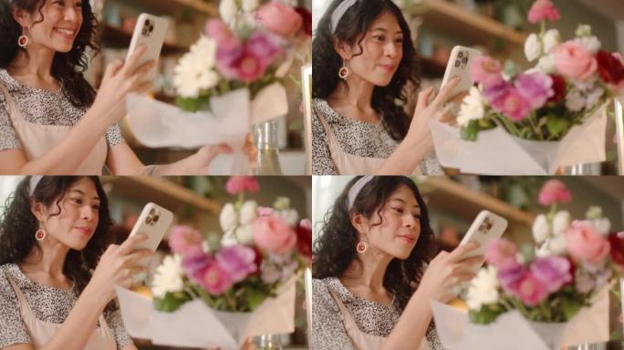 年轻的亚洲女性在商店里用智能手机摆放新鲜切花和拍照。