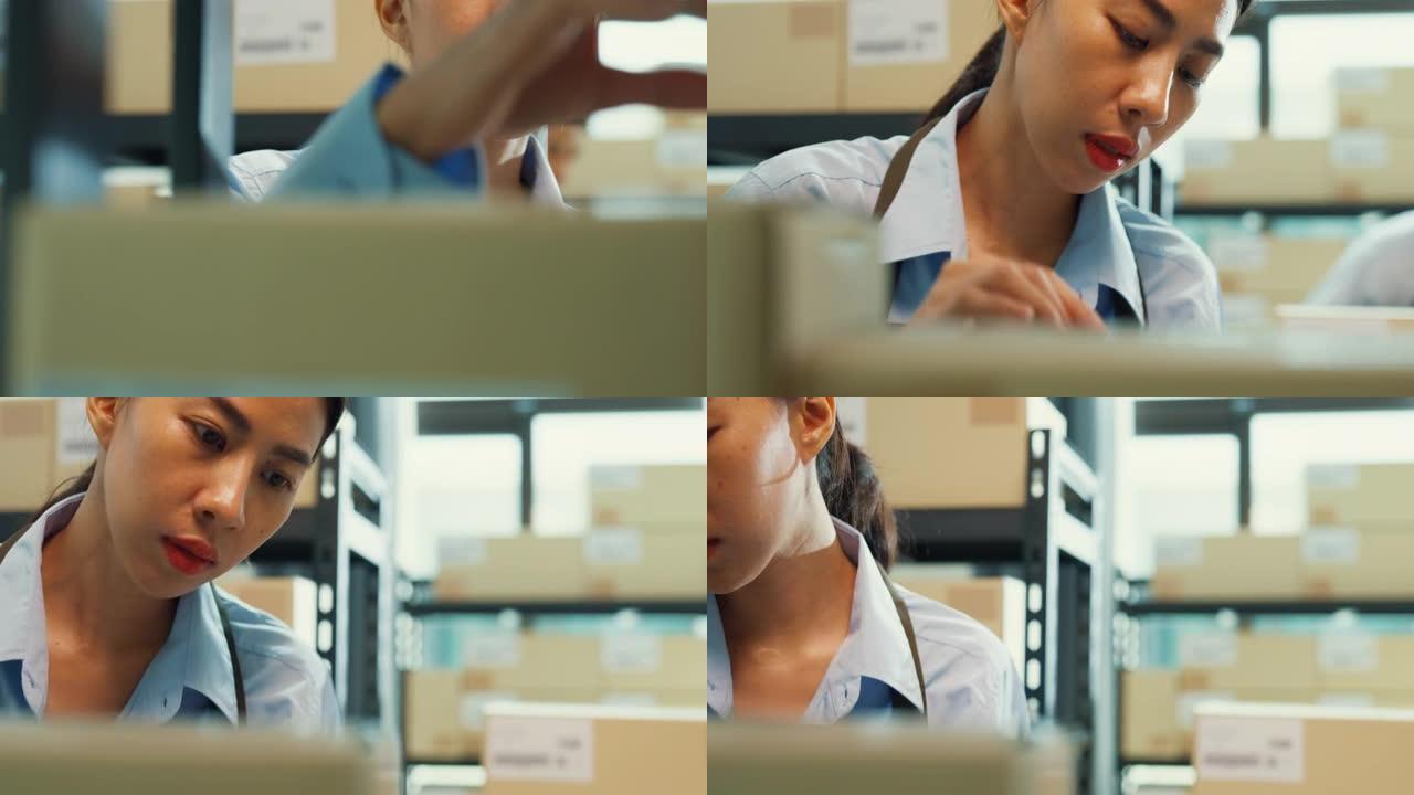 亚洲商业伙伴女人穿正式衬衫拿着数字平板电脑检查库存在线库存数据在货架上的纸板箱为客户在仓库交货。创业