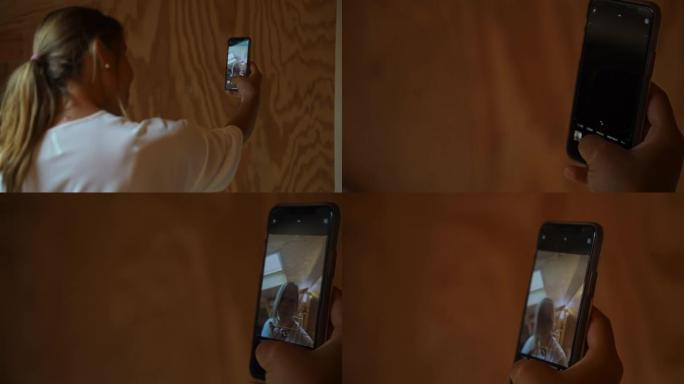 女人在小木屋里用手机摄像头自拍