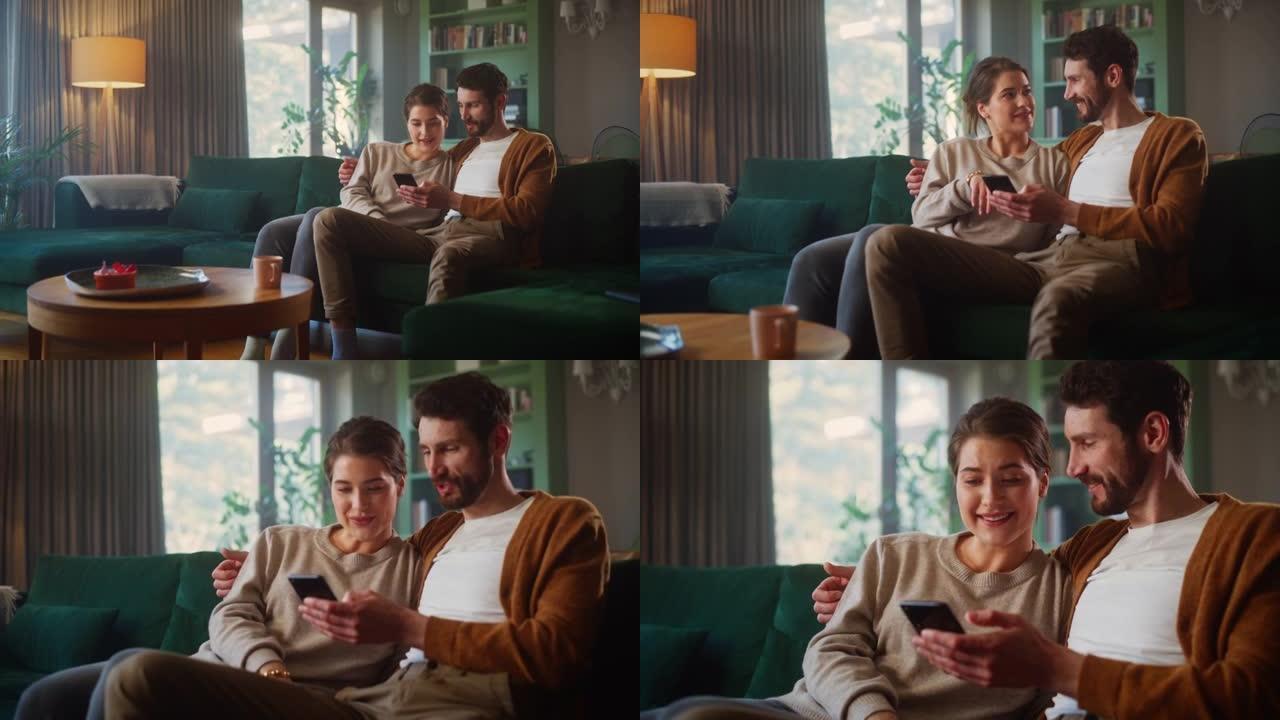 夫妇坐在舒适公寓的沙发上时，使用智能手机设备。男女朋友聊天，在互联网上购物，观看有趣的视频，使用社交