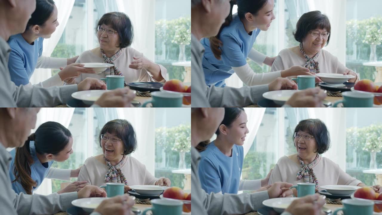 迷人的年轻亚洲老年公民夫妇在老年亚洲护理家庭护理中的日常生活方式中，早上在家里的餐桌上快乐地坐，聊天