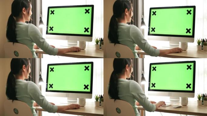 女人在家使用绿屏电脑