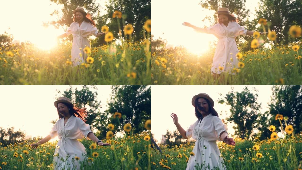美丽的年轻女子在日落中的黄花草地上奔跑