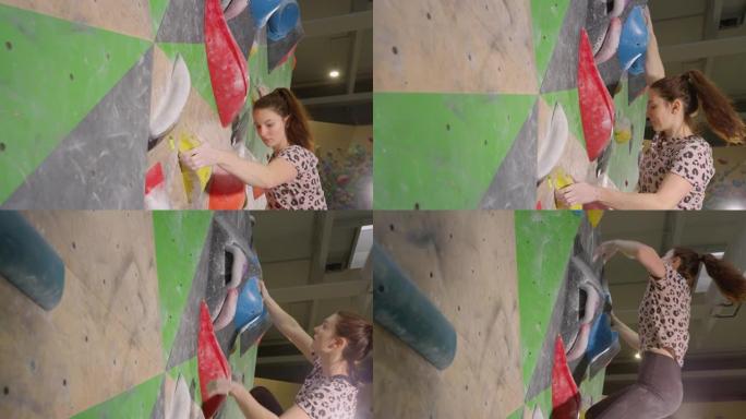 特写: 运动女子在攀岩健身房中攀登具有挑战性的路线。