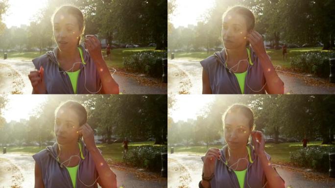 4k视频片段，一名年轻女子在锻炼前准备音乐