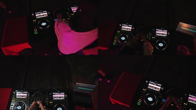 男性和女性DJ的手调整调音台上的音乐控制