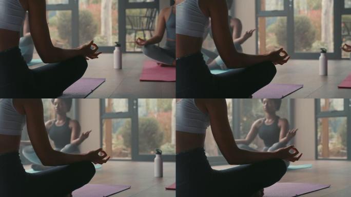 一群年轻女性在瑜伽课上冥想莲花姿势的4k视频片段