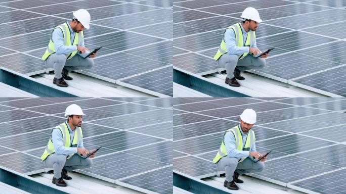 年轻的工程师或承包商在城市的屋顶上检查太阳能电池板。一位自信的年轻经理或维修工人在安装发电设备并拿着