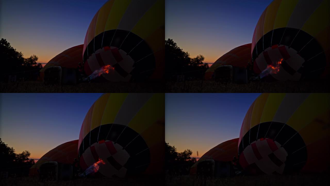 丙烷火焰在黎明时在野外充气热气球
