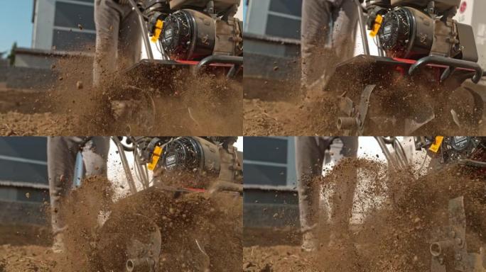 超级SLO MO园丁使用前齿耕作机犁过坚硬的污垢和土壤