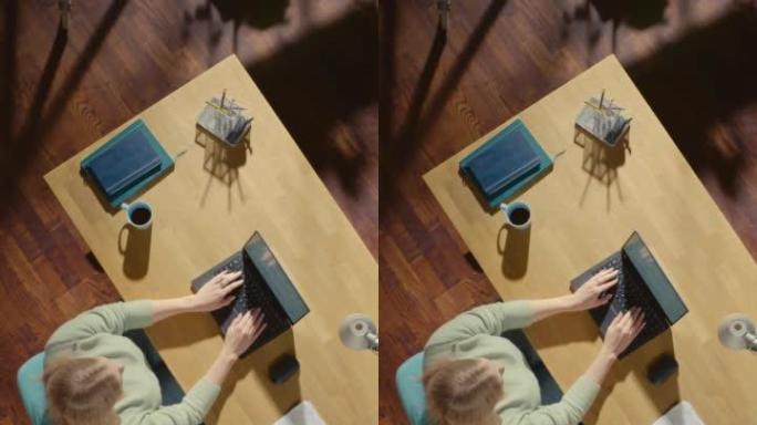 垂直屏幕顶视图: 坐在办公桌前的自由企业家打开笔记本电脑并开始工作。远程访问专业人员撰写电子邮件，管