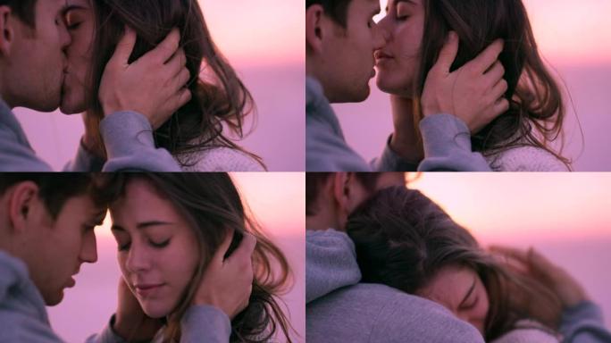 一对夫妇在日落时在海滩上亲吻和拥抱的4k视频片段