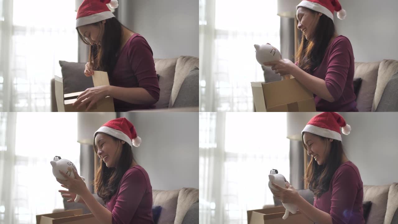 亚洲女性在圣诞节活动中打开包装