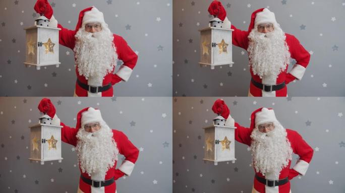 穿着圣诞老人西装的男人的肖像拿着灯笼，微笑着看着相机