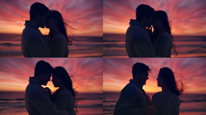 一对夫妇在日落时在海滩上接吻的4k视频片段