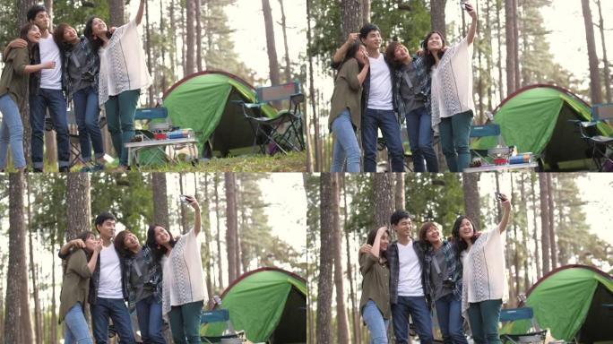 一群朋友四人快乐地走进松树林，在露营区享受
