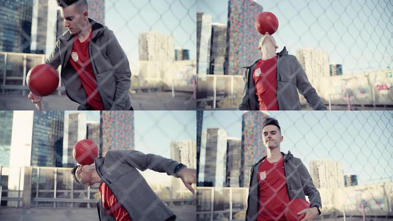 才华横溢的年轻足球运动员用旋转的红球杂耍技巧，将其握在手指和头上。在摩天大楼周围的城市中展示自由式技