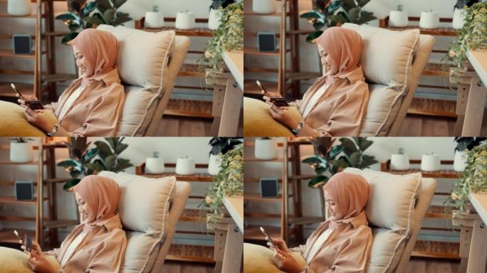 亚洲穆斯林女孩使用信用卡在线购物支付。
