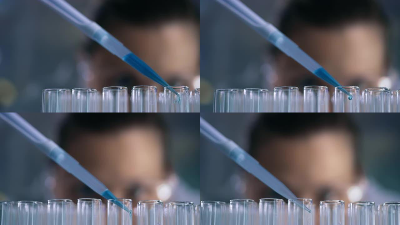 在实验室中使用滴管和试管的无法识别的科学家的4k视频片段
