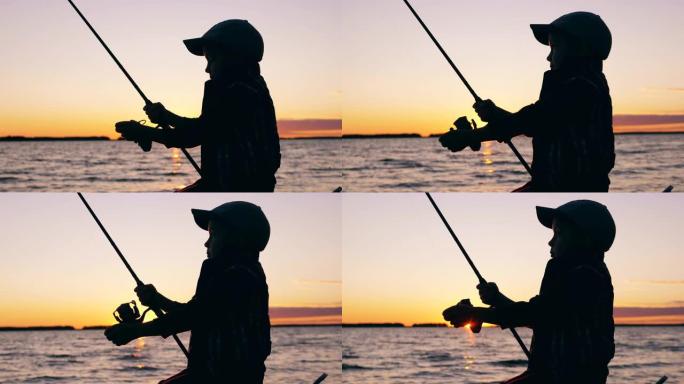 一个孩子在日落时用钓鱼竿钓鱼