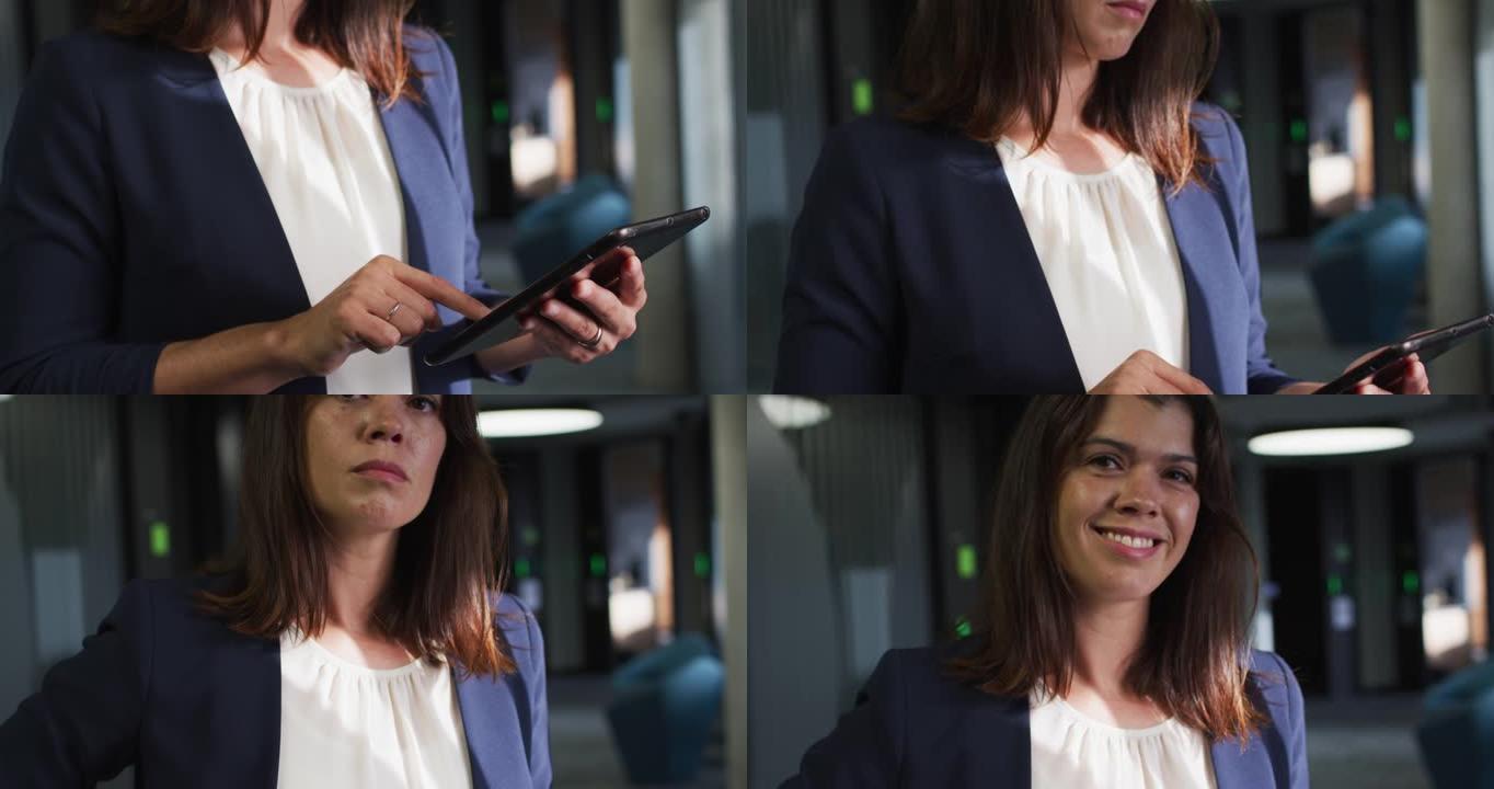 微笑的高加索女商人在现代办公室使用平板电脑的肖像